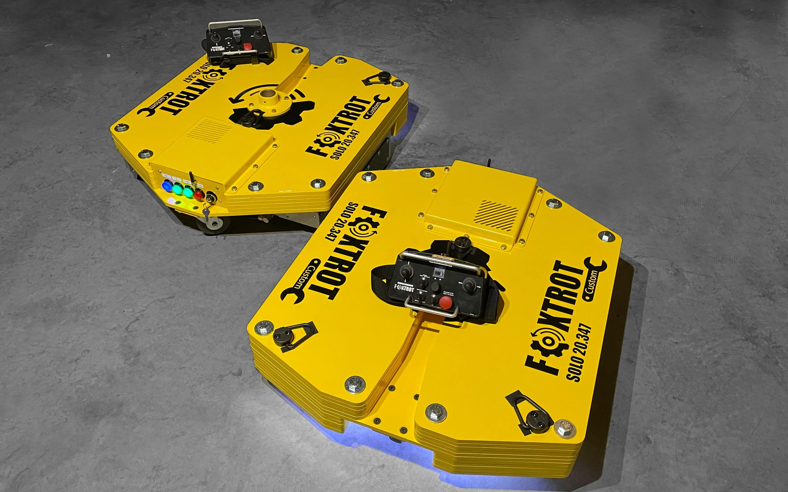 2 custom yellow foxtrot robots with the remote control on top